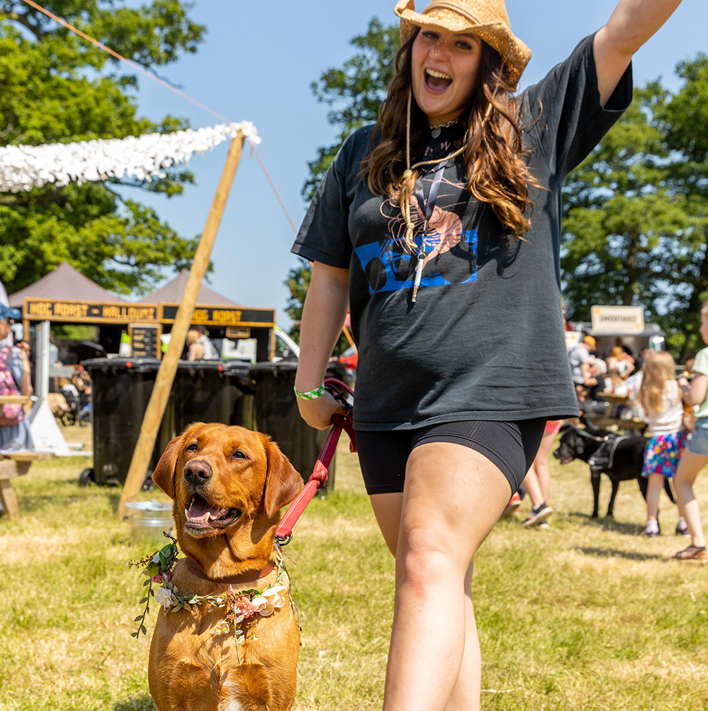 Woman and her dog smiling at Dogstival festival.