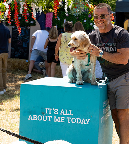 Photo of a man next to his dog on a podium.